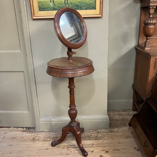 352 - A 19th century mahogany shaving mirror on turned support and tripod base