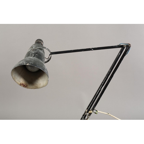 38 - A modernist angle poise desk lamp by Herbert Terry and Sons, Redditch, black enamel, on a two tier s... 