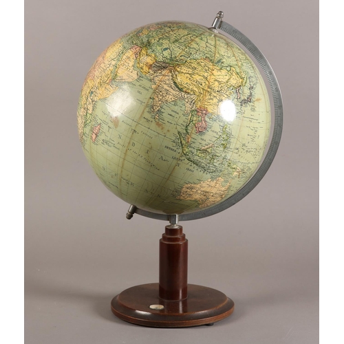 72 - A terrestrial globe, c1930s, with metal semi-meridian, the wooden circular base inset with a compass... 