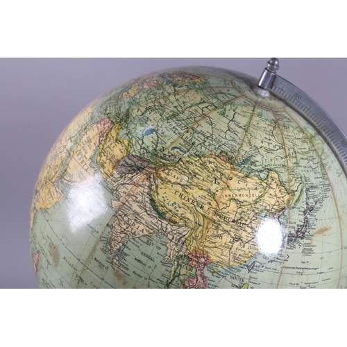 72 - A terrestrial globe, c1930s, with metal semi-meridian, the wooden circular base inset with a compass... 