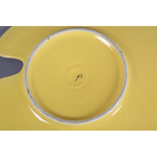 89 - An early 1960s studio pottery artist's palette dish, polychrome glazed, the underside yellow and pai... 