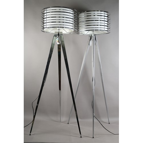 73 - A pair of polished metal floor lamps, by CIMC Home, pierced drum heads with internal off-white shade... 