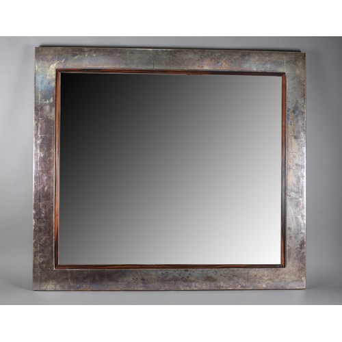 90 - A metal effect finish wall mirror with Macassar veneer slip, 112cm x 127cm