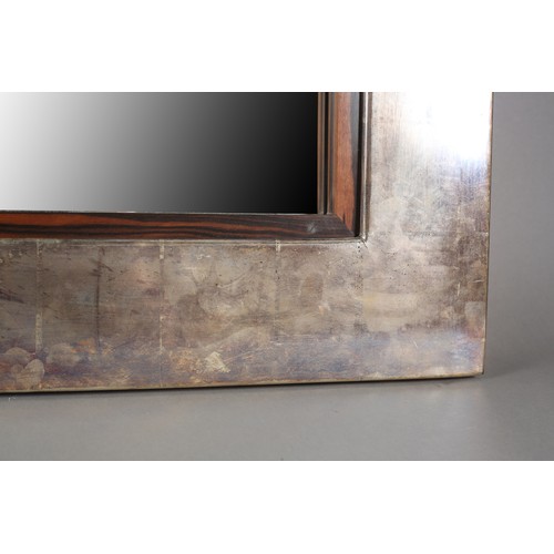 90 - A metal effect finish wall mirror with Macassar veneer slip, 112cm x 127cm