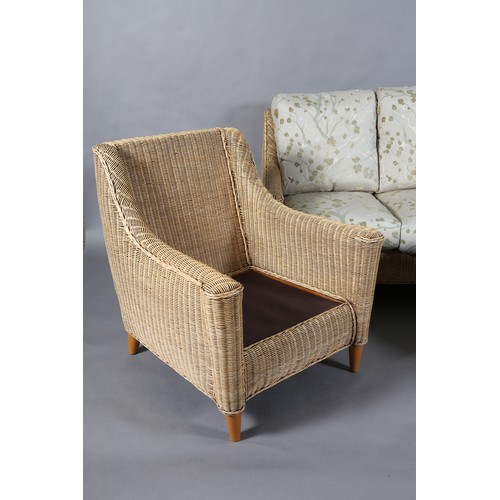 124 - A three piece wicker two seater sofa and pair of armchairs, the seat and back cushions upholstered i... 