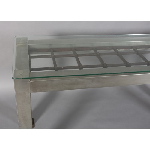 123 - A matt stainless steel console, rectangular, inset with a cast iron open grid, with glass surface 16... 