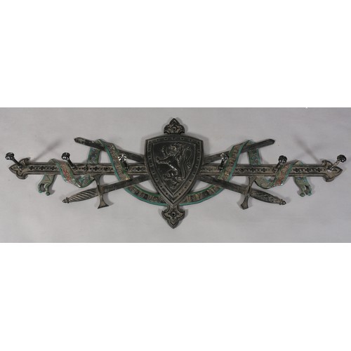 127 - A Victorian cast iron Scottish Baronial hat and coat rack formed as crossed swords and riband motto ... 