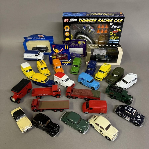 457 - A collection of 27 model cars from Corgi and Lledo, including 12 Morris Minor vans with various live... 