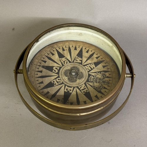 438 - A 19th century ship’s compass with brass body mounted on brass gimbal