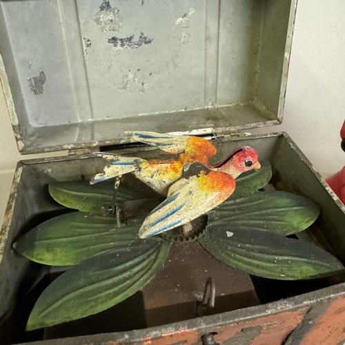 441 - A clockwork singing bird automaton in painted tin plate box, along with a spinning clockwork cellulo... 