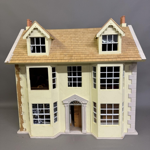 500 - A three-storey Edwardian style dolls house with opening front and roof, along with a quantity of fur... 