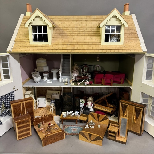 500 - A three-storey Edwardian style dolls house with opening front and roof, along with a quantity of fur... 