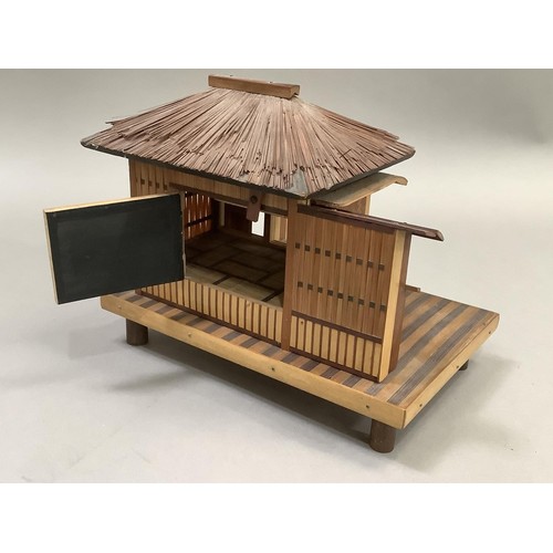 52 - Model of a Japanese house raised on a platform and with bamboo feet. 23.5cm wide x 15.5cm deep x 20c... 