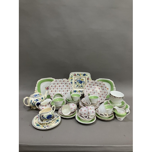 115 - A green and gilt Grosvener tea service comprising eight cups, thirteen saucers, two sugar bowls, mil... 