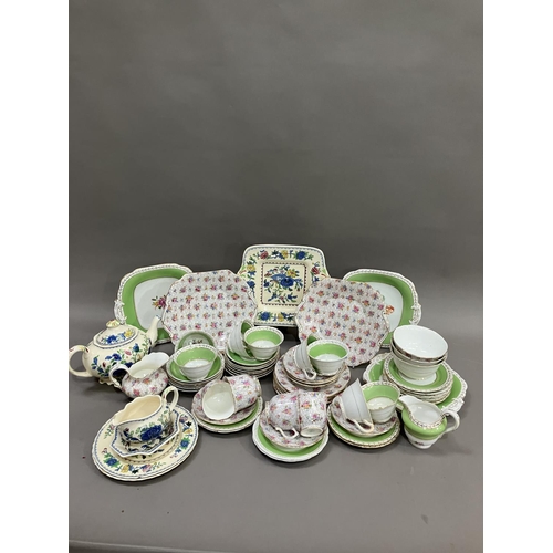 115 - A green and gilt Grosvener tea service comprising eight cups, thirteen saucers, two sugar bowls, mil... 