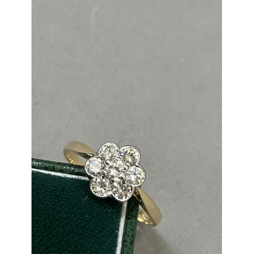 276 - A diamond cluster ring in 18ct yellow and white gold c1995, the brilliant cut stones collet and claw... 