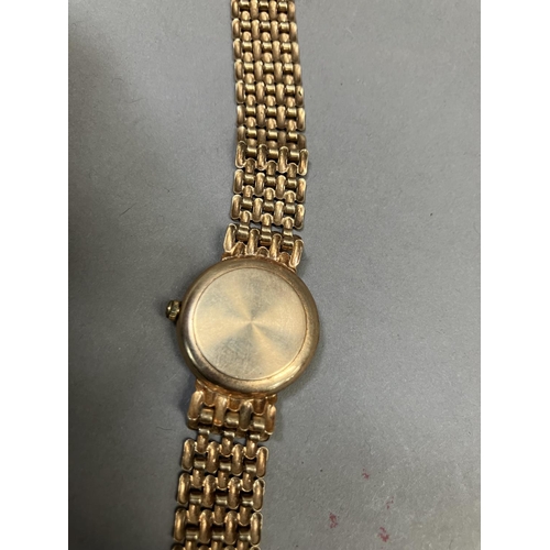 274 - A Geneve lady's quartz wristwatch in 9ct gold case on an integral gate type bracelet, matt gilt dial... 