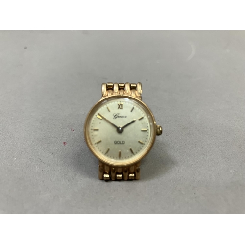 274 - A Geneve lady's quartz wristwatch in 9ct gold case on an integral gate type bracelet, matt gilt dial... 