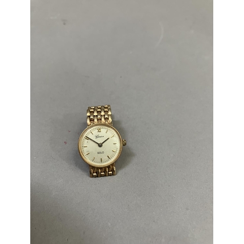 274 - A Geneve lady's quartz wristwatch in 9ct gold case on an integral gate type bracelet, matt gilt dial... 