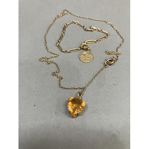 267 - A heart-shaped citrine pendant claw set in 9ct gold gallery mount hung on a fine trace link chain to... 