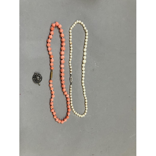 266 - A mid 20th Century coral necklace of 5.5mm spherical beads, approx. length 36cm, fastened with a 9ct... 