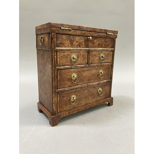 12 - An early 20th century burr walnut and satinwood veneered specimen chest, having a foldover top, twin... 