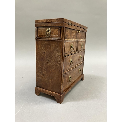 12 - An early 20th century burr walnut and satinwood veneered specimen chest, having a foldover top, twin... 