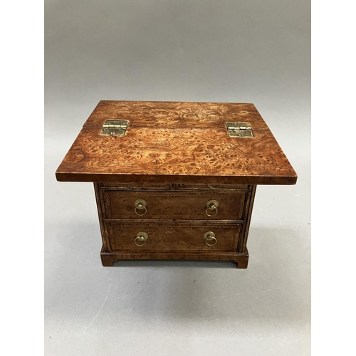 12 - An early 20th century burr walnut and satinwood veneered specimen chest, having a foldover top, twin... 