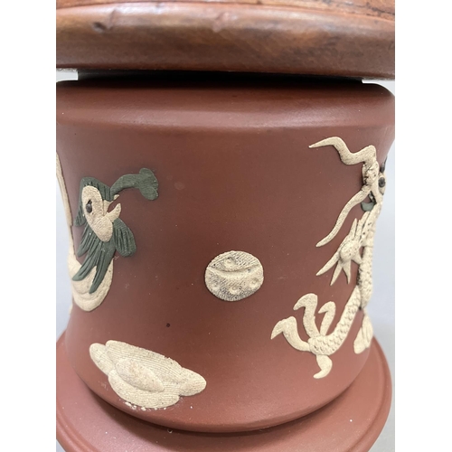 13 - A Chinese Zisha terracotta jar, the body applied with a dragon and ornamental bird having an associa... 