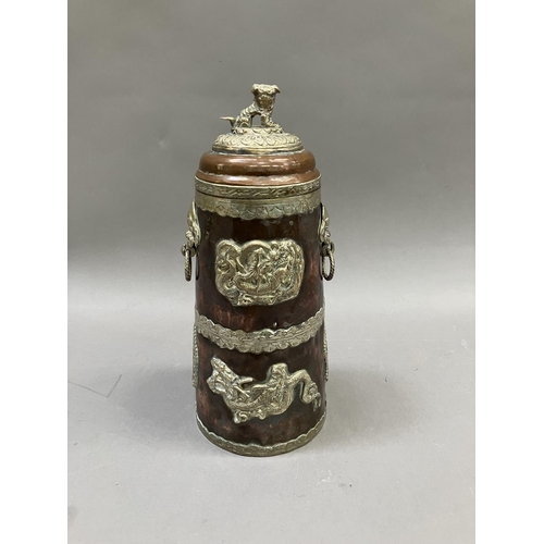 14 - A Tibetan copper container of tapered form, with applied metal mounts of dragons, the cover having a... 