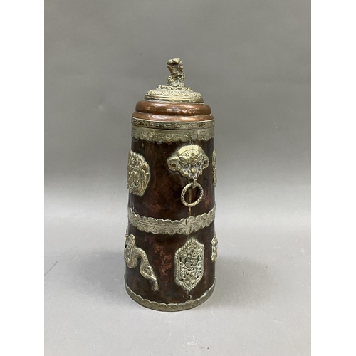 14 - A Tibetan copper container of tapered form, with applied metal mounts of dragons, the cover having a... 