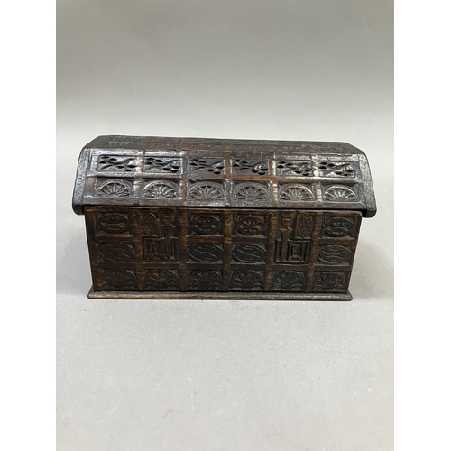 15 - An oak dome topped tea caddy, in the form of a coffer, the exterior heavily carved, stamped H. Uphil... 