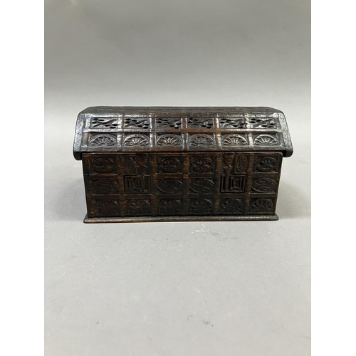 15 - An oak dome topped tea caddy, in the form of a coffer, the exterior heavily carved, stamped H. Uphil... 