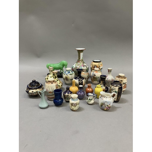 229 - A Chinese famille rose bottle neck vase, 12cm high together with a collection of 23 miniature vases ... 