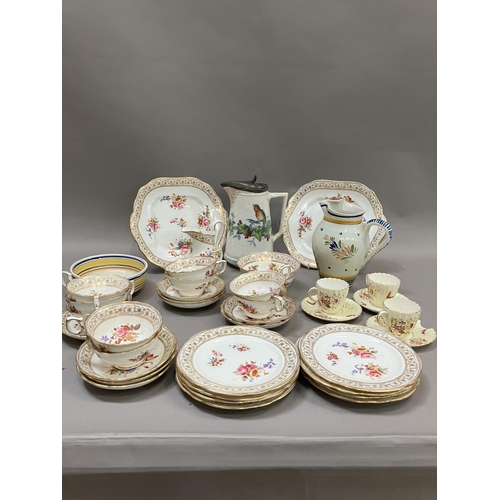 124 - An English tea service printed and enamelled with sprays of flowers including nine cups, nine saucer... 