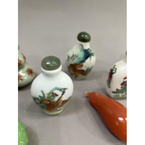 214 - A collection of eleven modern Chinese snuff bottles, in porcelain, agate etc