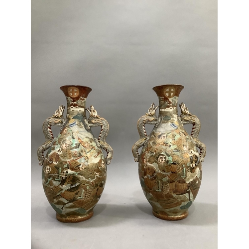 16 - A pair of late 19th Century Japanese Satsuma pottery vases by Fuji San, the ovoid bodies with twin d... 