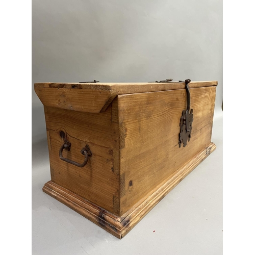 171 - A pine and metal bound trunk with lock and key, 76cm high x 35cm