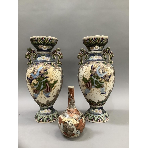 111 - A pair of early 20th Century Japanese pottery two handled vases enamelled in green, blue, madder and... 