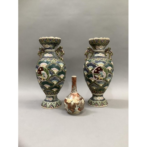 111 - A pair of early 20th Century Japanese pottery two handled vases enamelled in green, blue, madder and... 