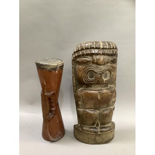 85 - A wooden Polynesian carving of a figure with open mouth 49cm high together with a drum, with reptile... 