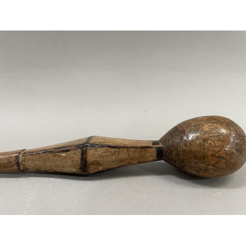 84 - An African staff having a rounded knop with incised decoration above a carved section with burnt dec... 