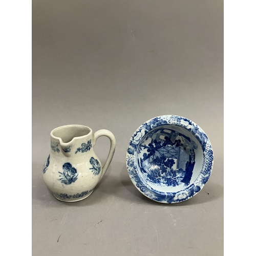 23 - A 19th Century pottery cream jug stencilled in blue with a repeat pattern of a flowering plant in a ... 