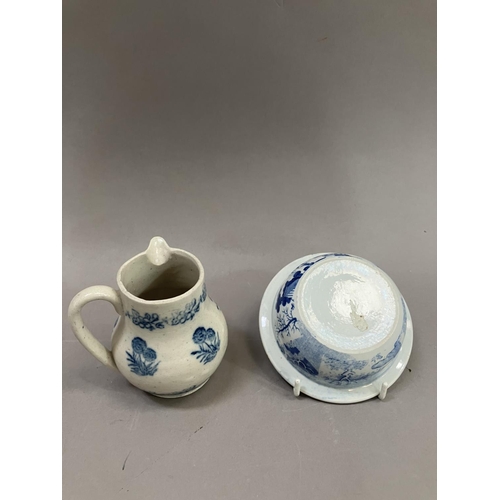 23 - A 19th Century pottery cream jug stencilled in blue with a repeat pattern of a flowering plant in a ... 