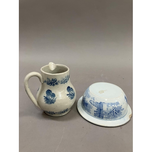 23 - A 19th Century pottery cream jug stencilled in blue with a repeat pattern of a flowering plant in a ... 