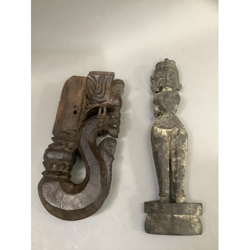 56 - A Indian carved hardwood figure of a woman, having a carved coiffure, narrow waist in ceremonial dre... 