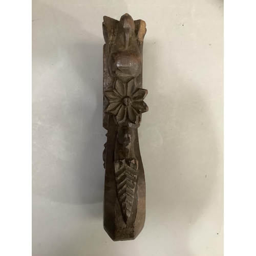 56 - A Indian carved hardwood figure of a woman, having a carved coiffure, narrow waist in ceremonial dre... 