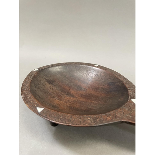 62 - Fijian ceremonial kava oil bowl, on three supports with incised geometric decoration and inset with ... 