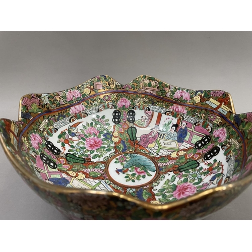 64 - A Chinese famille rose bowl having a border of gilding to the scalloped edge, enamelled with figures... 