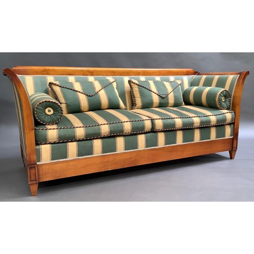 356 - A cherry wood sofa in Empire style, over scrolled arms, on tablet headed squat square tapered legs, ... 